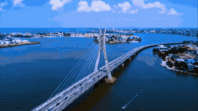 Aerial view of a Nigerian cable-stayed bridge spanning calm coastal waters